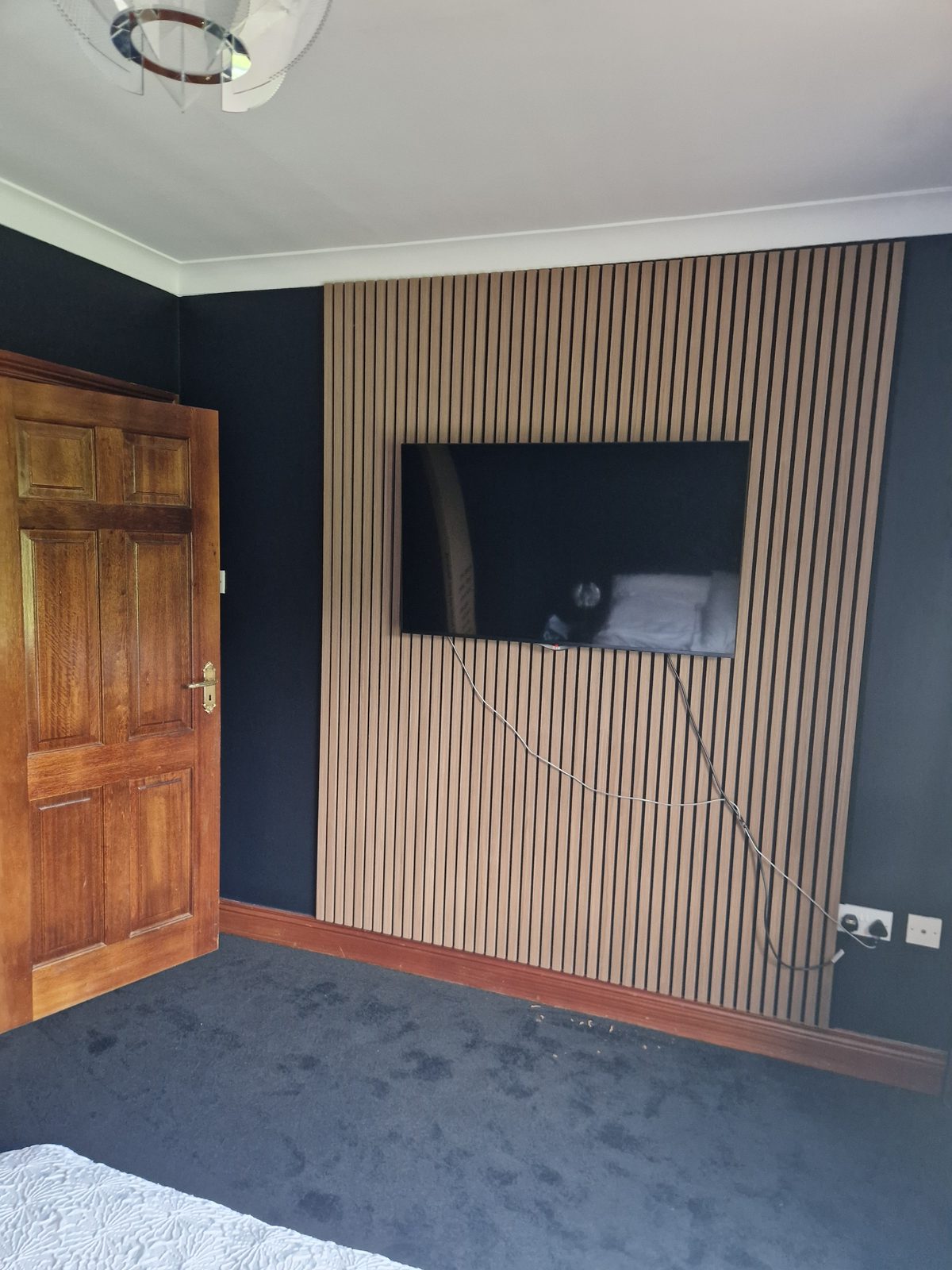 Slatted walnut feature wall with recessed television