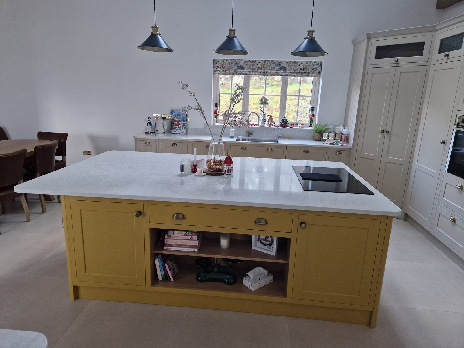 Mustard painted island with white quartz top and open shelving